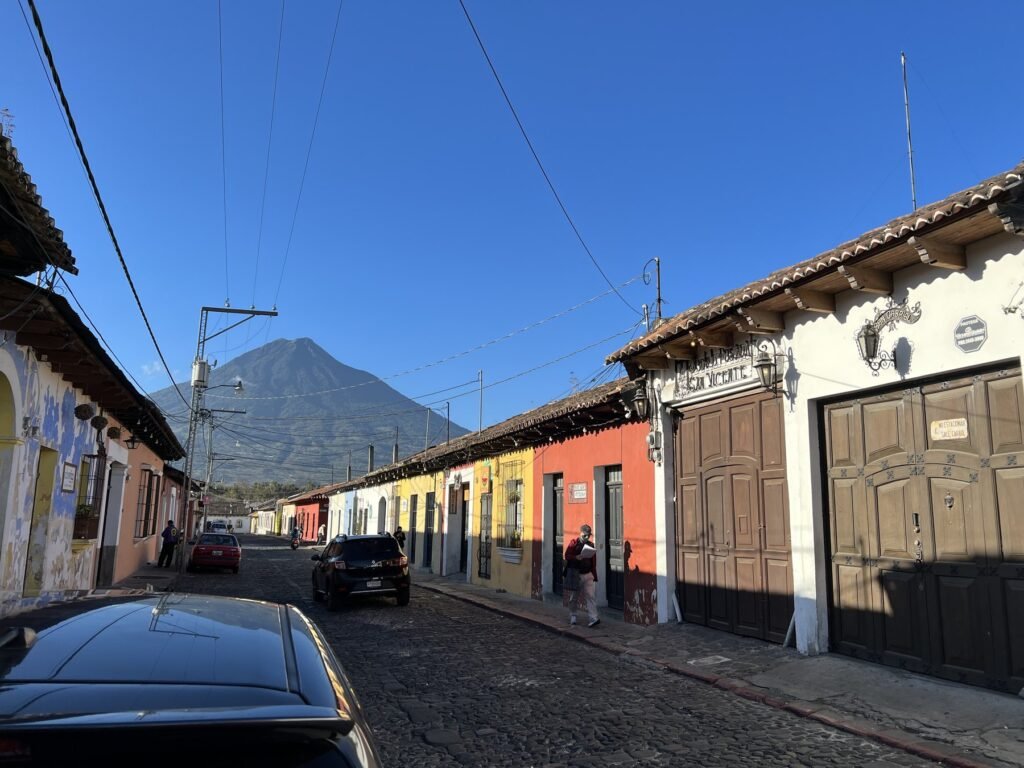 A colourful street in Antigua, Guatemala, looking towards Volcan de Agua at sunrise